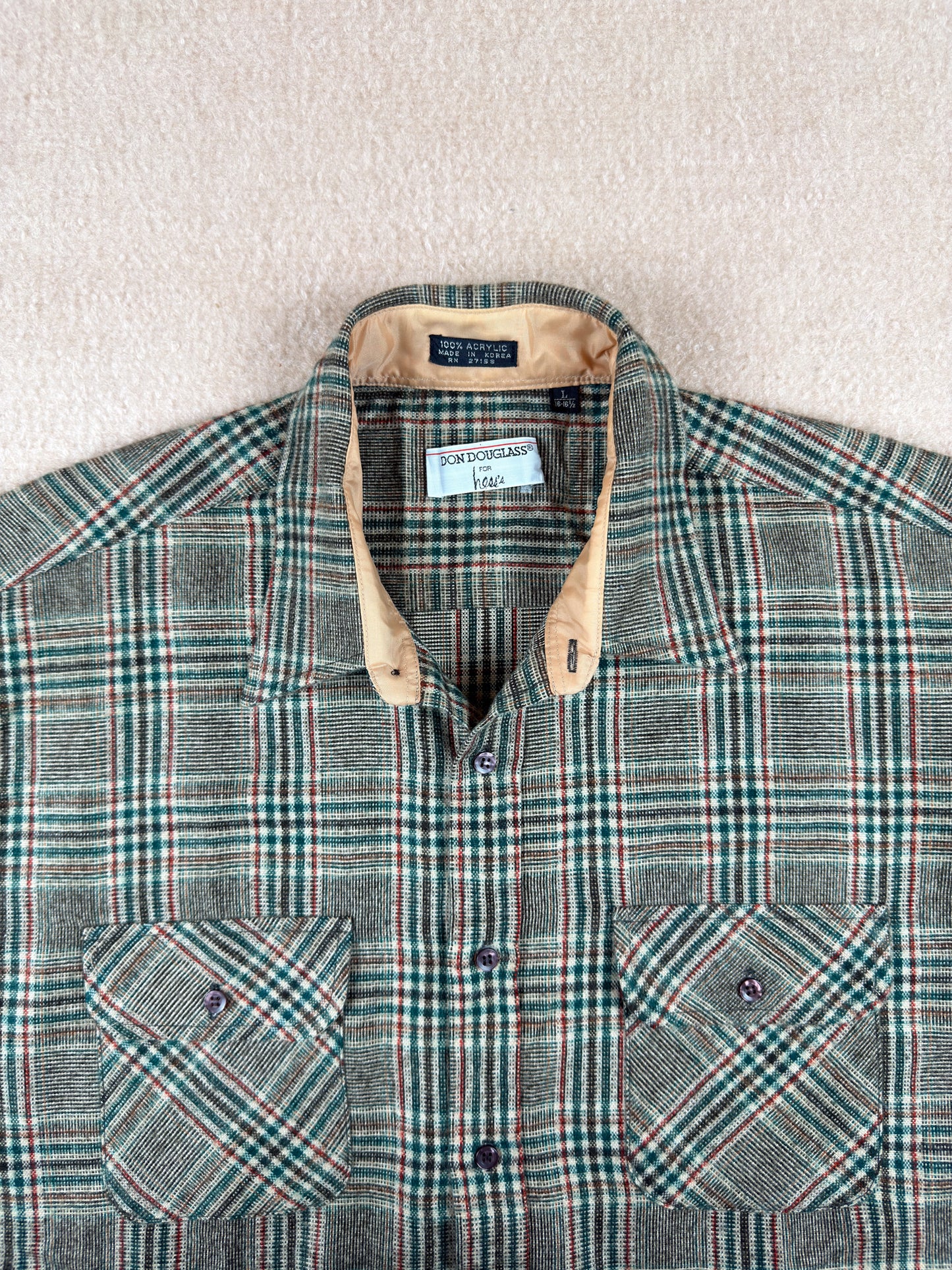 Plaid shirt with a Ralph Lauren tag on a neutral background
