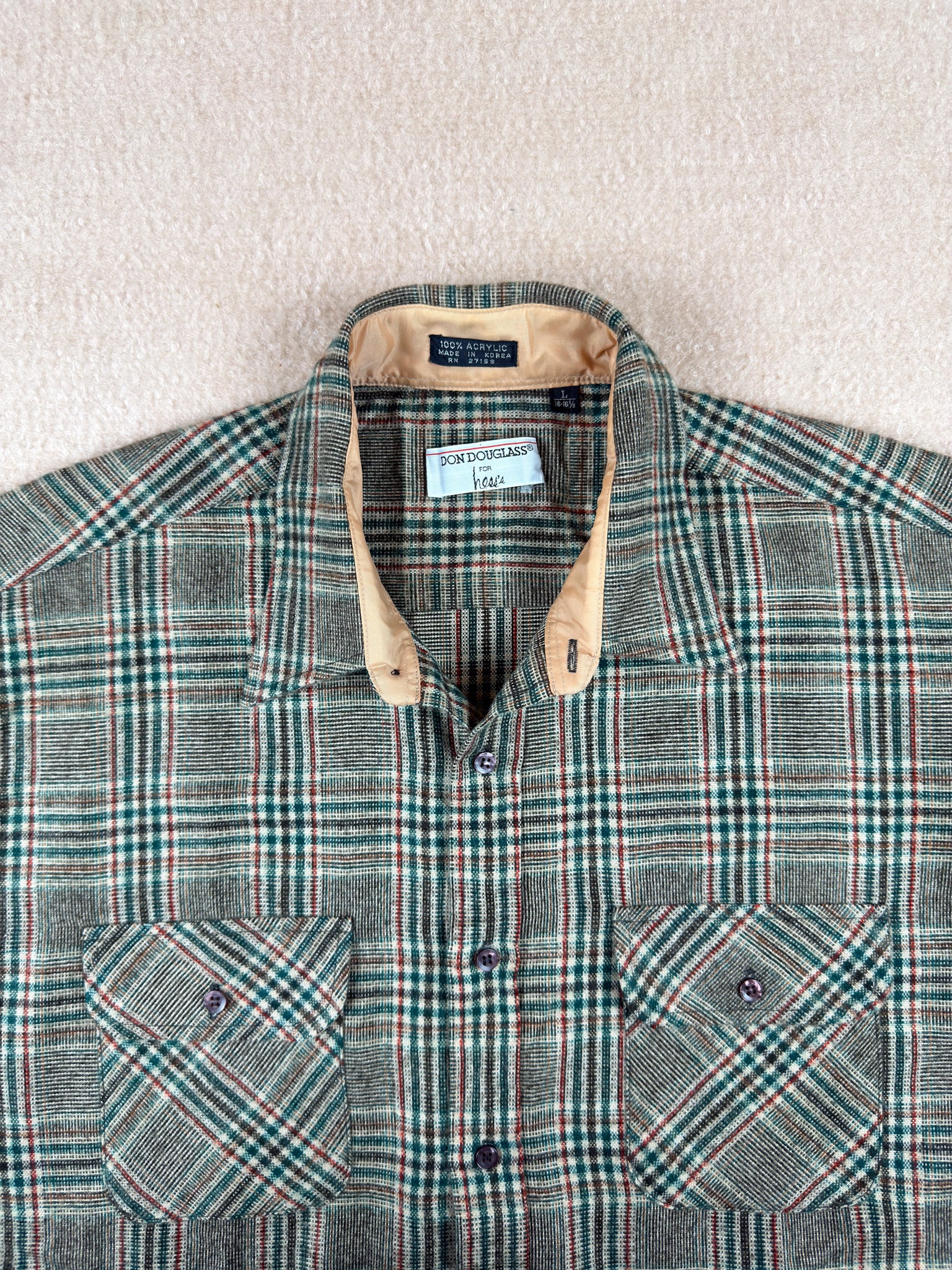 Plaid shirt with a Ralph Lauren tag on a neutral background